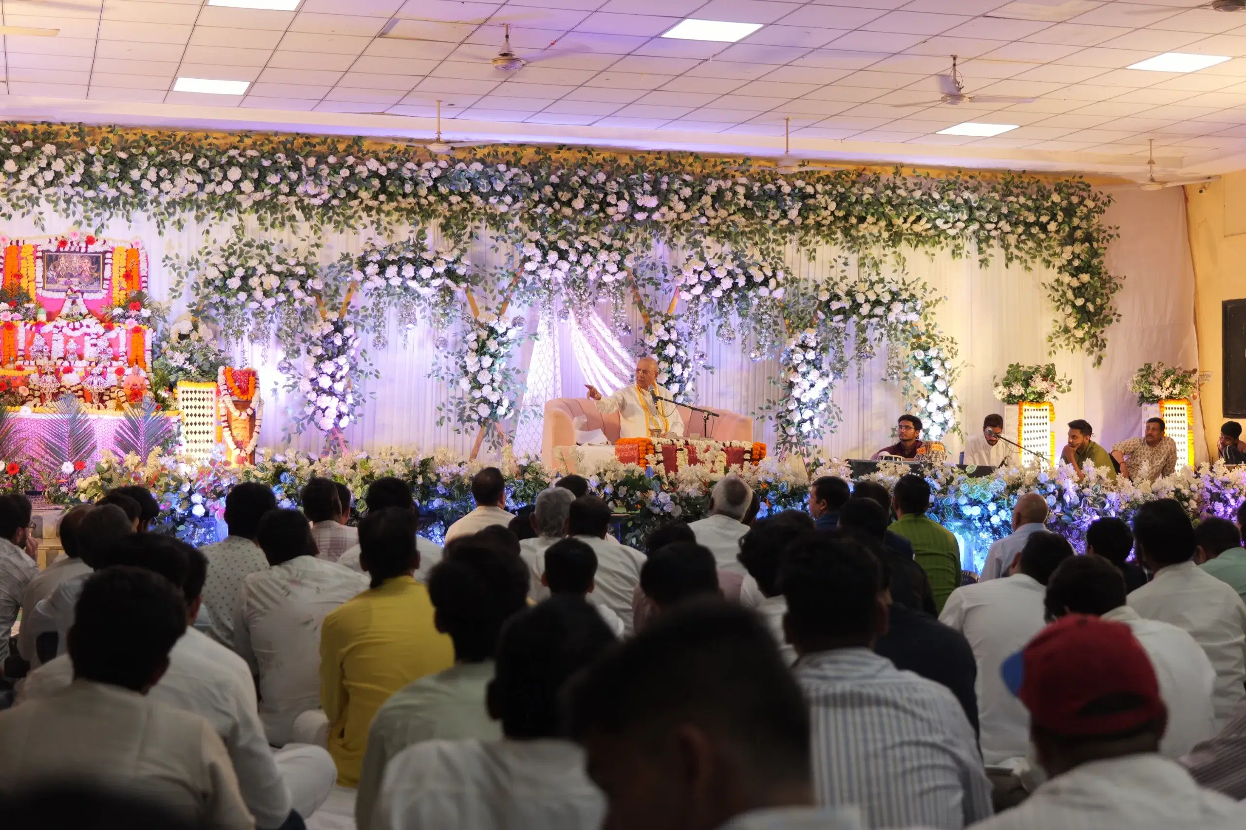 Devotees conducting a Kartik house program with a family