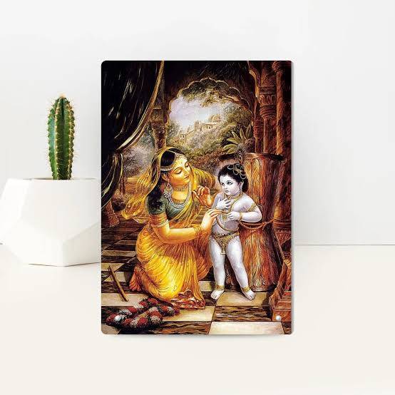 Yashoda Damodar acrylic frame on a wooden altar with lit diyas and marigolds
